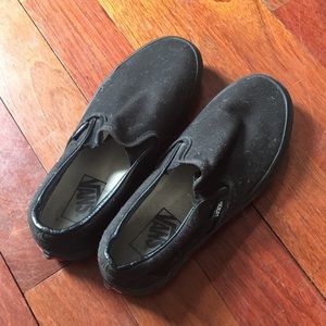All black Vans slip-on sneakers